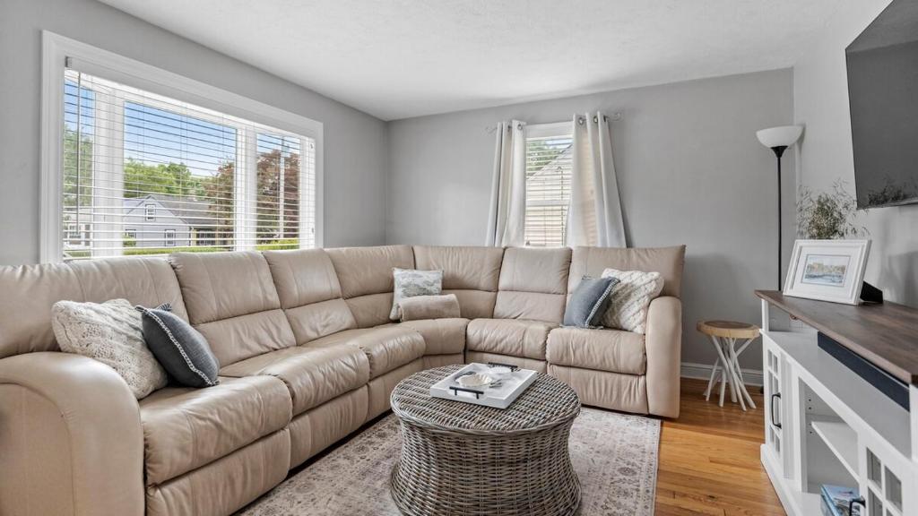 a living room with a couch and a table at Newport Beach House with Huge Yard in Middletown