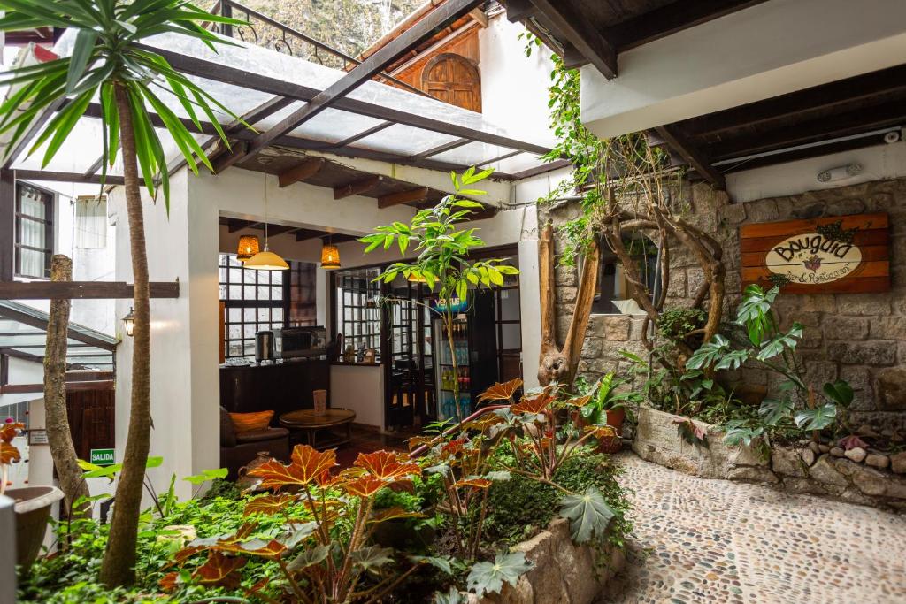 a patio with a bunch of plants and a building at Gringo Bill's Boutique Hotel in Machu Picchu