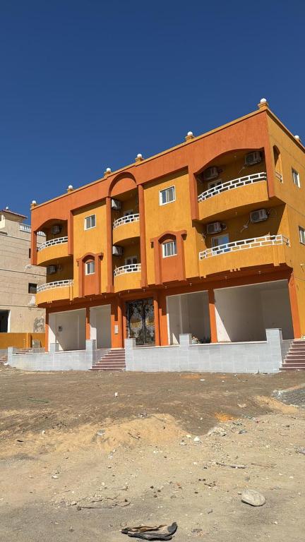 an orange building with balconies on the side of it at Melia house in Marsa Alam City