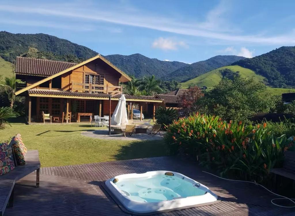 a house with a jacuzzi in the yard at Rancho São Jorge in Macaé