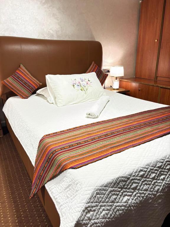 a hotel room with a large bed with white sheets at بيت الطبيعة nature house in Jerash