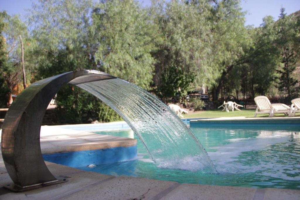 
a fountain in the middle of a swimming pool at Rocas Amarillas in Valle Grande
