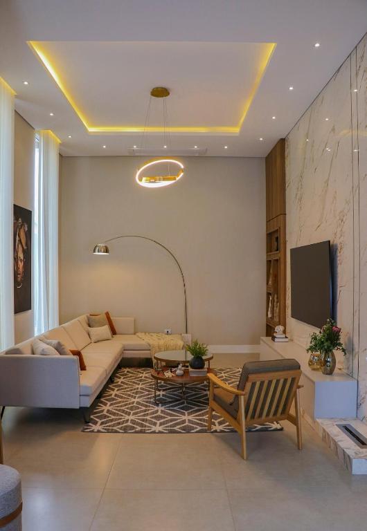 a living room with a couch and a tv at Loft do Edu in Ortigueira