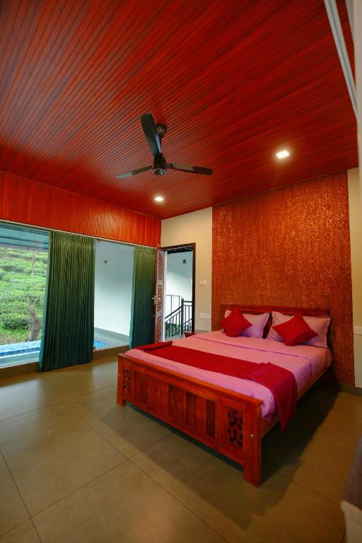 a bedroom with a large red bed with a ceiling at Private Pool Villa by Green View in Vythiri
