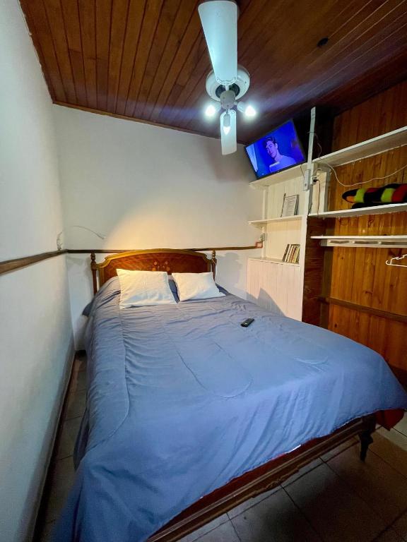 a bedroom with a blue bed with a ceiling at Rincón verde in Eldorado