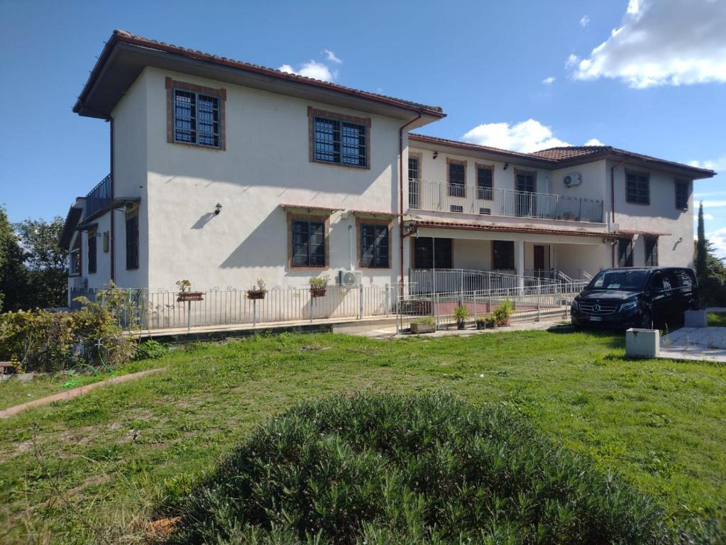 a house with a car parked in front of it at Villa Crisett in Civitella San Paolo