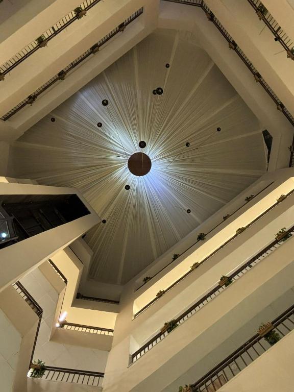 a ceiling of a building with a clock on it at Ammania Hotel in Amman