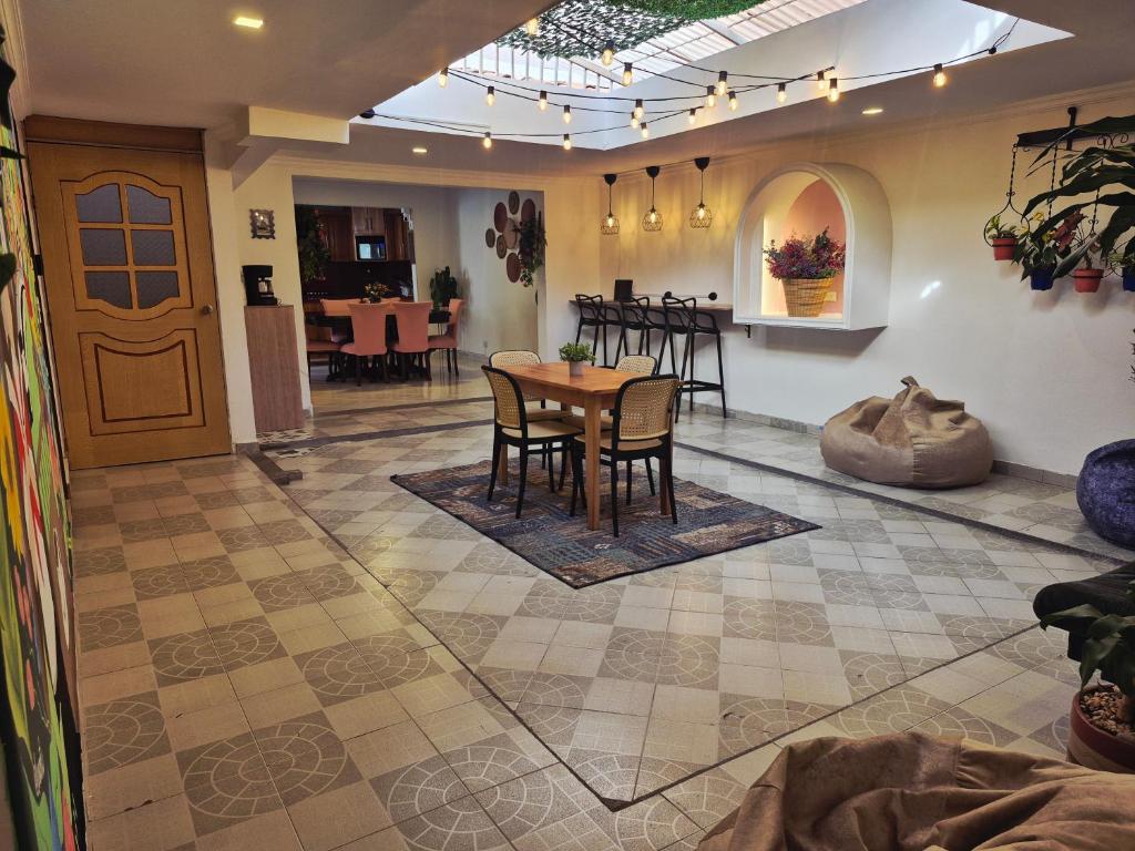 a dining room and kitchen with a table and chairs at Kaobba Hostal in Medellín