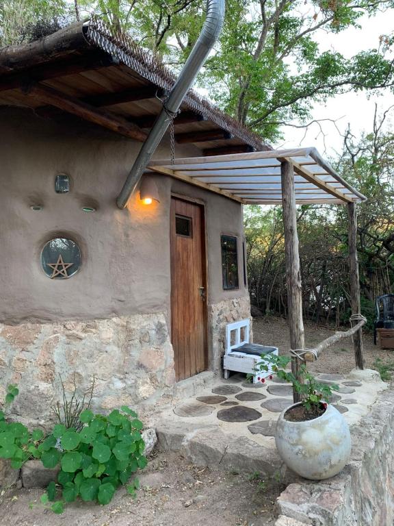 a house with a wooden door and a bench outside at El Jopi in Tanti