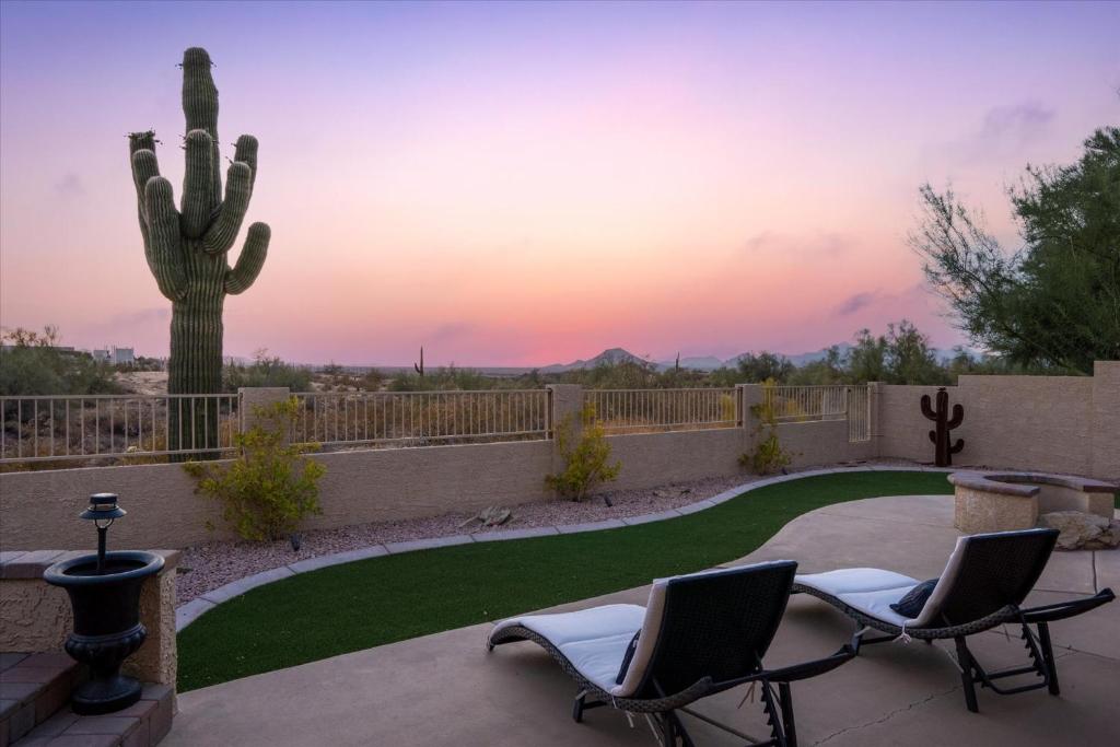 un patio con 2 sillas y un cactus en Desert Sunset, en Leisure World