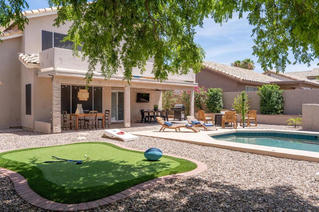 a home with a miniature golf course in the yard at Red Mountain Retreat in Leisure World