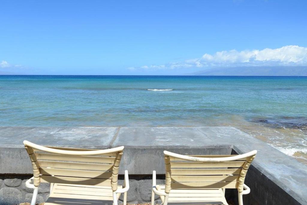 two chairs sitting next to the ocean at Kulakane 105 · KK105 Sunsets Ocean Views Oceanfront in West Maui in Kahana