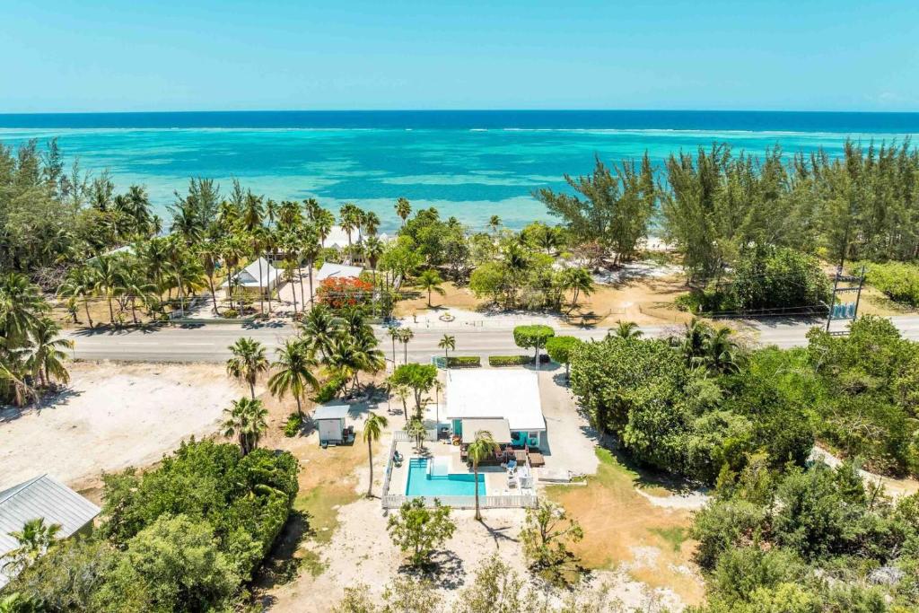 an aerial view of a resort with the ocean at Sea Beauty - Charming Cottage with Pool and Private Beach Lot in North Side