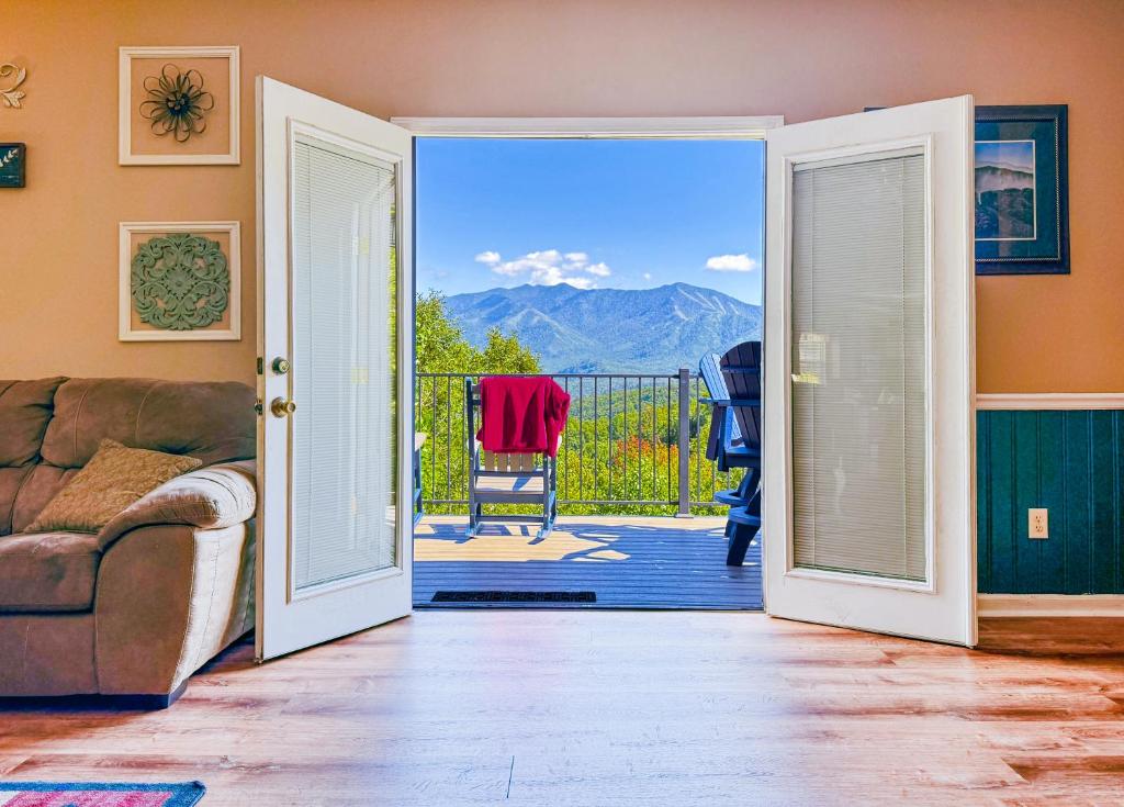 a living room with a door open to a balcony at Mountainview Majesty in Gatlinburg