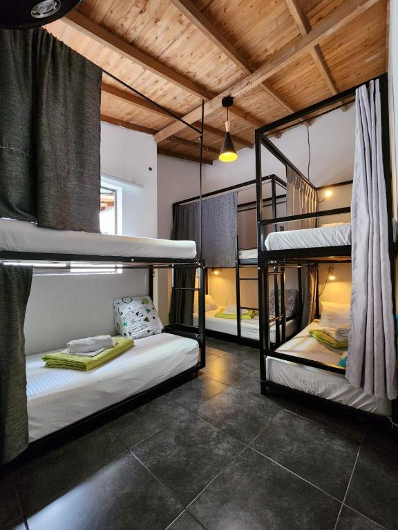 a room with three bunk beds in it at Hostel Metro Floresta Alojamiento in Medellín