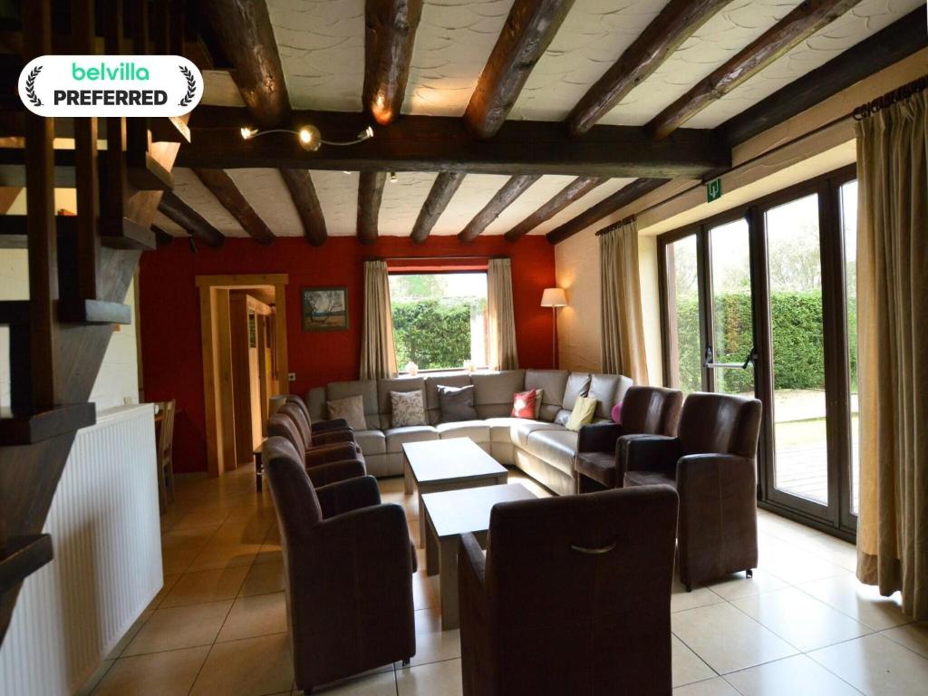a living room with couches and a table and chairs at Elegant Bevercé Escape in Malmedy