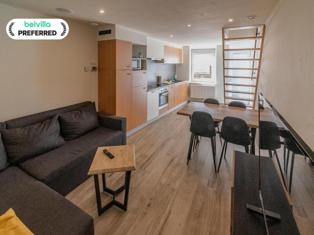 a living room with a couch and a table at Holiday Home in La Roche near Center in La Roche-en-Ardenne