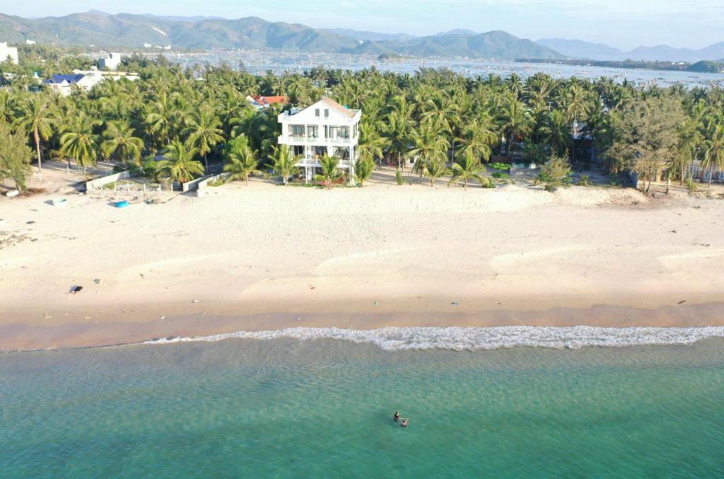 an aerial view of a beach with a house at Timothe Beach Hotel & Apartments in Song Cau