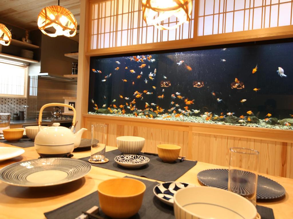 a dining table with a large aquarium in the background at asterisk HIROSHIMA in Hiroshima