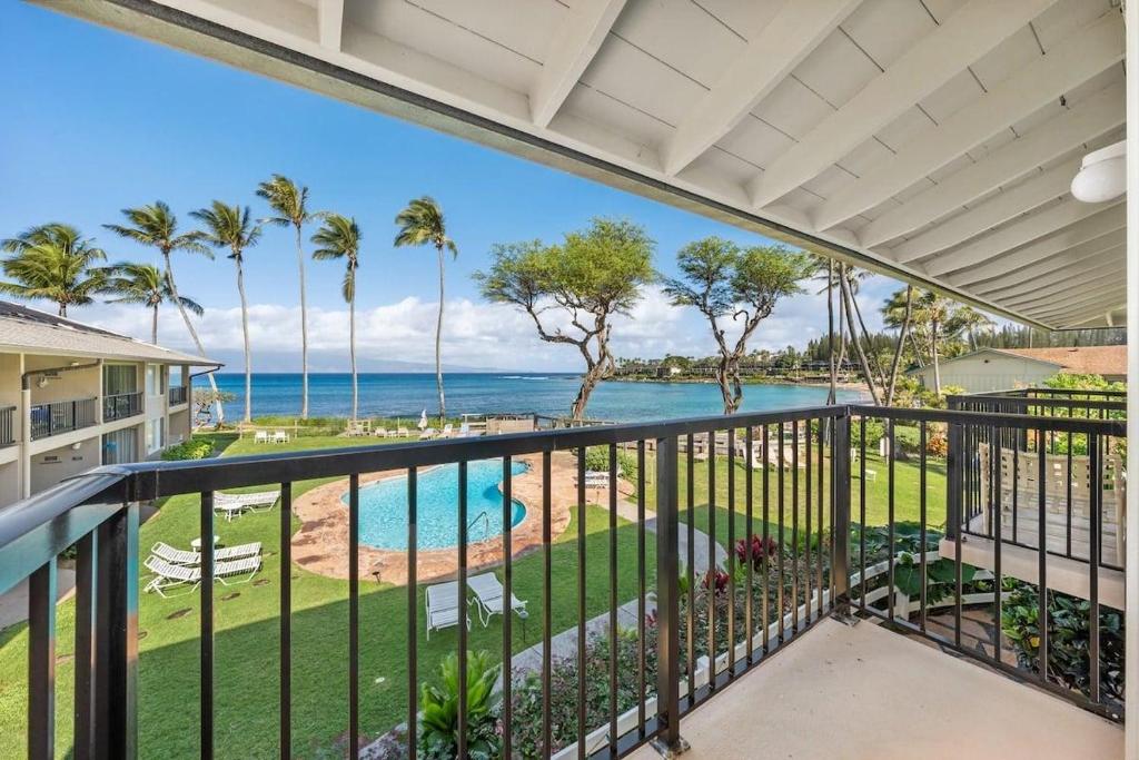 a balcony with a view of the ocean at Napili Surf 207 · NSF 207 BeachFront Condo Napili Bay in Kahana
