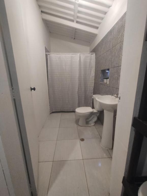 a bathroom with a toilet and a sink at playa pescador apart hotel in Santa Fe