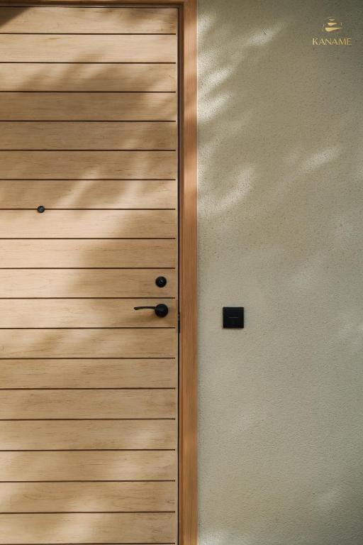a wooden door in a room with at Kaname in Liên Trì (4)
