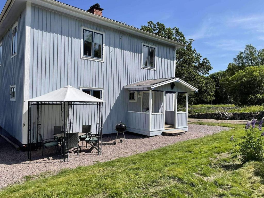 a house with a gazebo and a table and chairs at 4 star holiday home in TORSÅKER in Torsåker