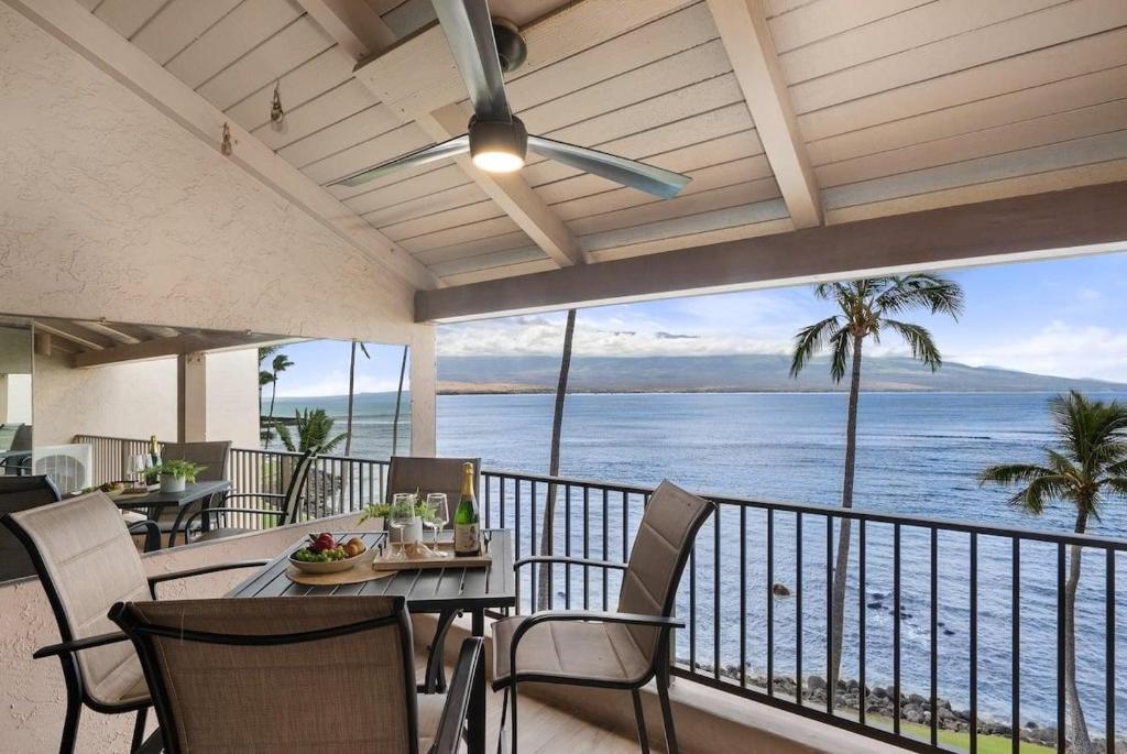 a dining room with a view of the ocean at Lauloa 403 · LOA 403 Fully Remodeled Direct Oceanfront 2BD in Wailuku