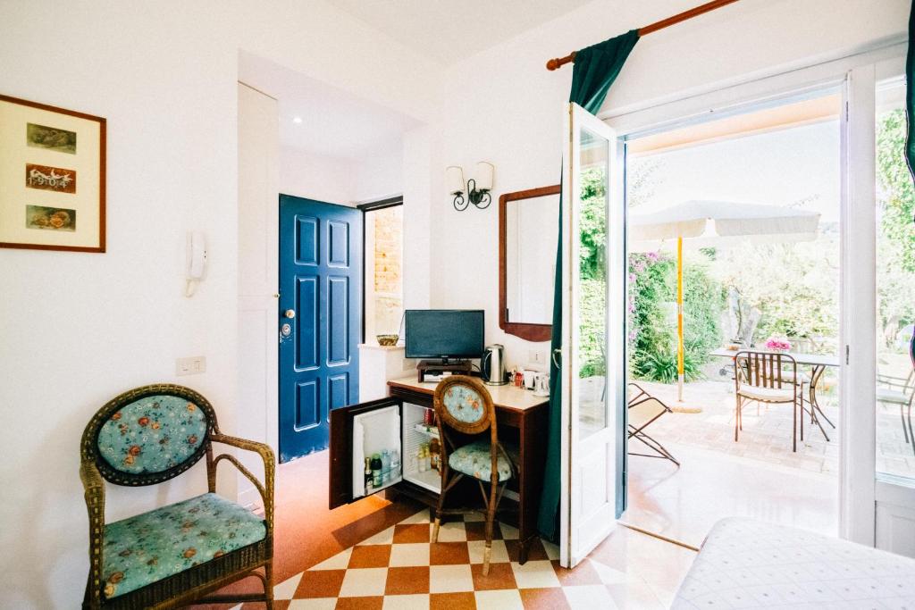 a living room with a door open to a patio at Villino Eleonora in Parghelia