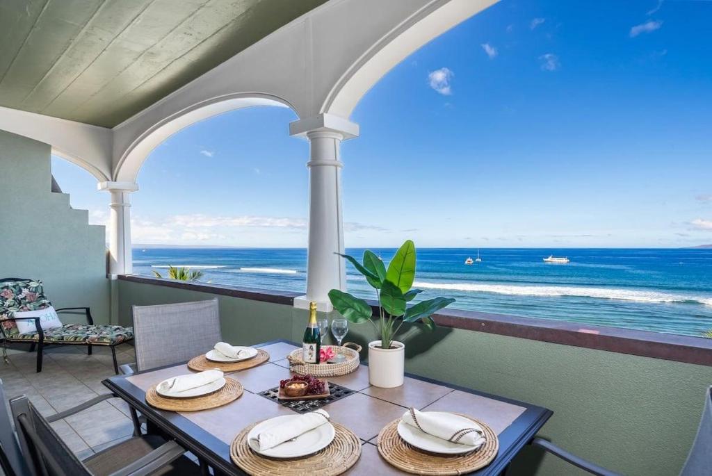 a dining room with a table with a view of the ocean at Lahaina Shores PH1 · LS PH1 Oceanfront Penthouse Condo w Panoram in Lahaina