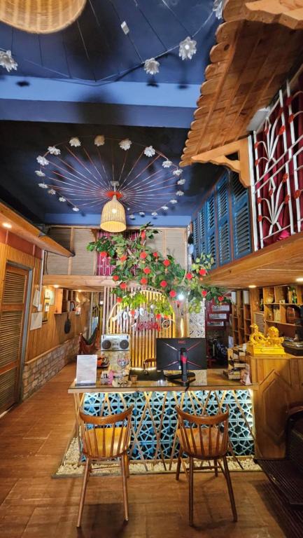 a restaurant with two chairs and a counter with plants at 1984 Hotel - Phú Gia Island Amusement Park, Rach Gia in Ấp Rạch Mẹo
