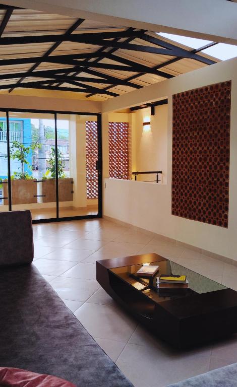 a living room with a couch and a coffee table at Spacious apartment in Buga, super central in Buga
