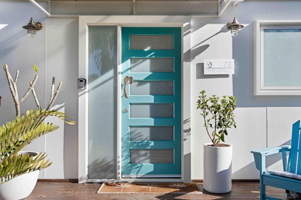 a blue door in a room with plants at The Chill - Your Dreamy Waterfront Escape in Sanctuary Point