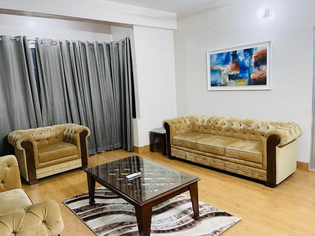 a living room with two couches and a coffee table at Bashundhara Luxury 3BR Apartment Near Evercare in Dhaka