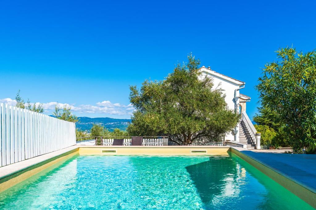a swimming pool in the backyard of a house at Holiday house Anita in Šilo
