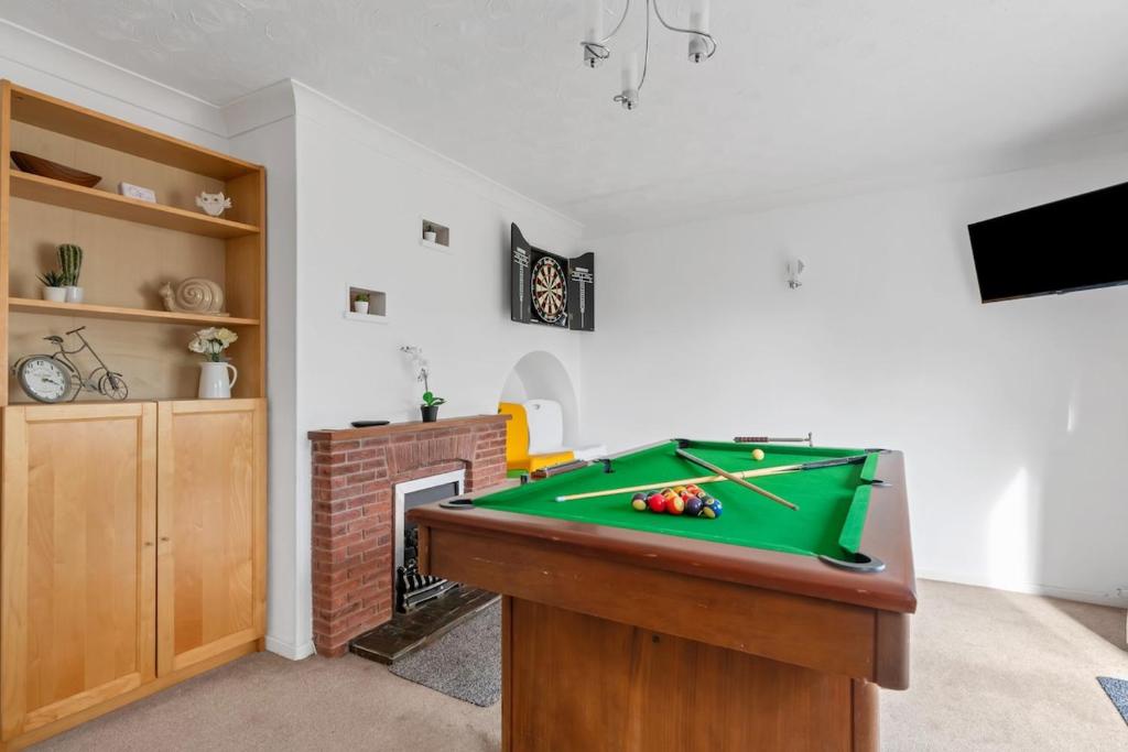 a living room with a pool table and a fireplace at Awesome Games Room House! EMA Donington Park, with FREE parking in Kegworth
