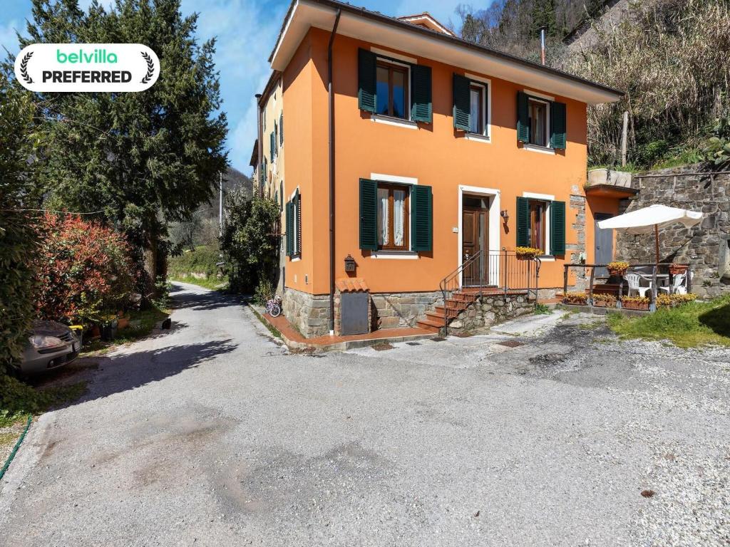 a small orange house with a gravel driveway at Hillside Home in Marliana in Marliana