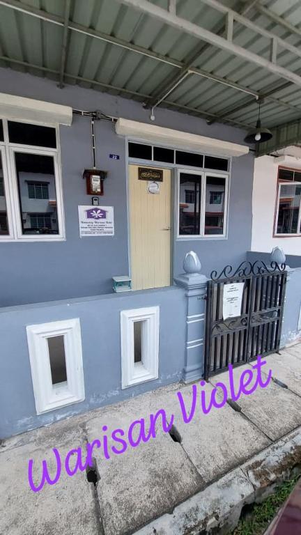 a blue and white building with a door at Homestay Warisan Violet Tg Minyak in Malacca