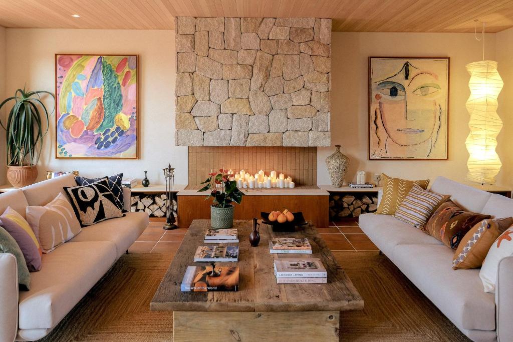 a living room with couches and a coffee table at Buenadumo Jeju Tennis Holiday Villa in Sinch'ang-ni