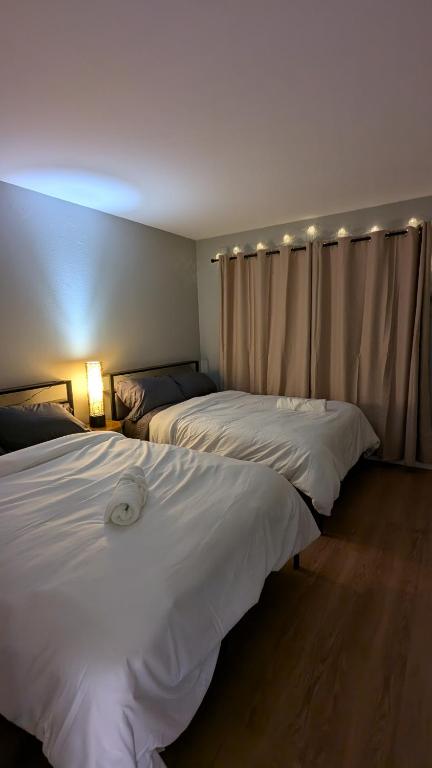 a hotel room with two beds and a window at Serene home in Simi valley, CA in Simi Valley
