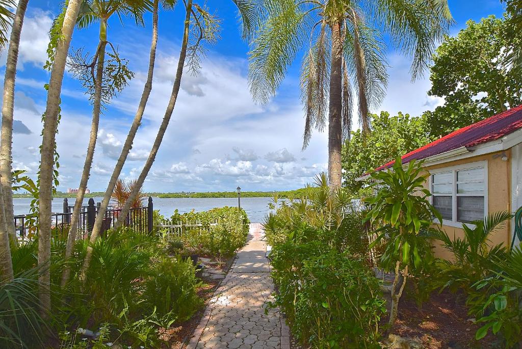 a house with a pathway next to a body of water at Turtle Beach Resort in Siesta Key