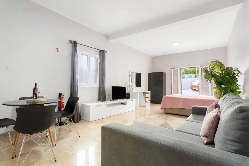 a living room with a couch and a bed at Studio Home Away from Home in Caniçal