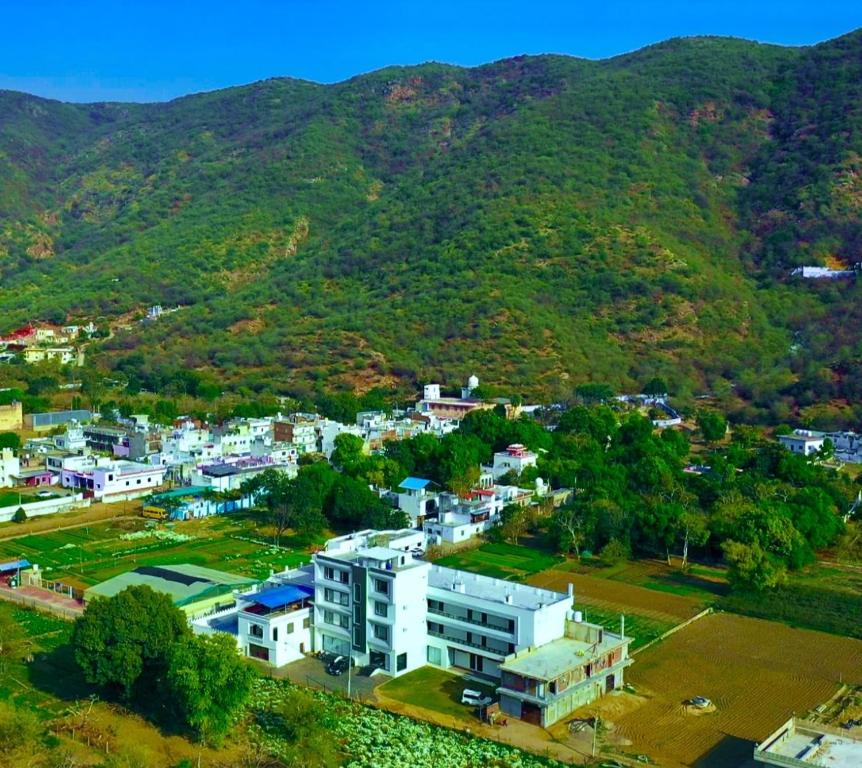 an aerial view of a city with mountains in the background at HOTEL TRIPLE SEVEN , Pushkar - A Beautiful Resort Nested in Nature's Lap in Pushkar