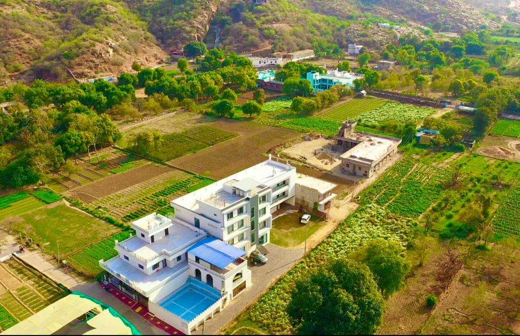 an aerial view of a large white house with a yard at The Shining Star 777 , Pushkar - A Beautiful Resort Nested in Nature's Lap in Pushkar