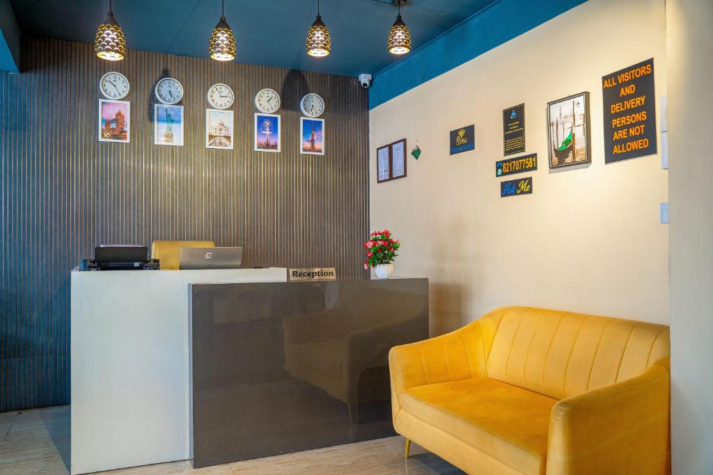 a waiting room with a counter and a chair at Open Hotel by Olive - Meet Me At in Bengaluru