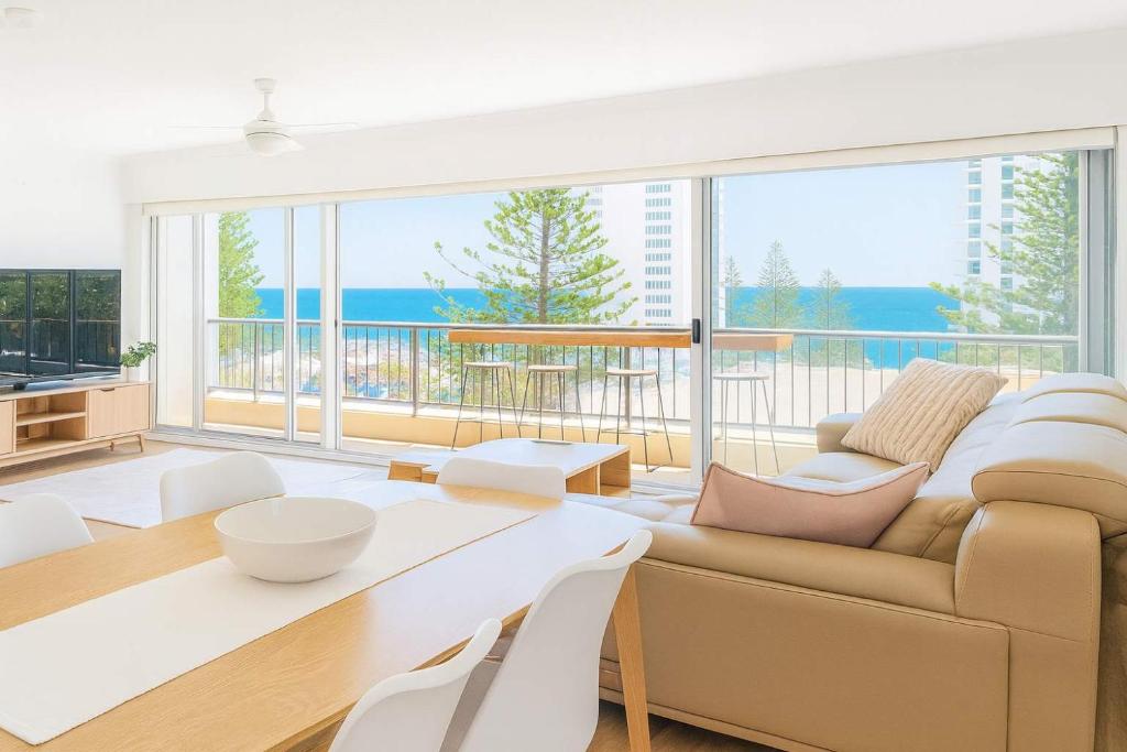 a living room with a couch and a table at Snapper Rocks Ocean view Retreat in Coolangatta