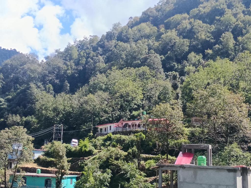 a house on the side of a mountain at Global home stay in Sari