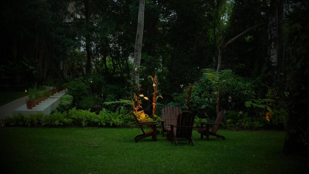 two chairs sitting in a yard at night at Casa Colonial Beach & Spa in San Felipe de Puerto Plata