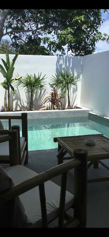 Nathon BayにあるMini villa and its beautiful private pool 4のテーブルと椅子が隣接するスイミングプールを利用できます。