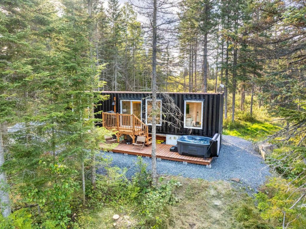 a black tiny house in the woods at Spa & River view - Le Conteneur Cache in Saint-Just-de-Bretenières